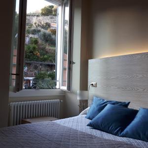 a bedroom with a bed with a large window at Bellambra in Monterosso al Mare