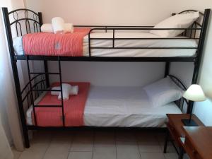 two bunk beds in a room with a desk at Skala Pearls A1 in Skala Kefalonias