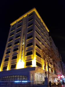 a lit up hotel building at night at Ismira Hotel Ankara in Ankara