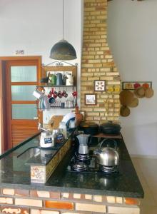 a kitchen with a stove with pots and pans at Pousada Romã in Paraty
