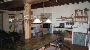 a kitchen and dining room with a table and chairs at La Vache Tennis Privé in Crux-la-Ville