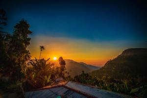 a view of the sun setting over the mountains at Wood Heart in Ella