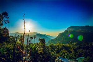 a view of the mountains with the sun in the sky at Wood Heart in Ella