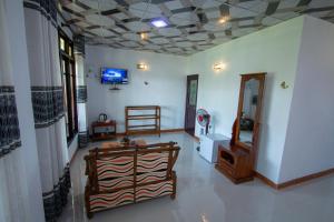 a living room with a chair and a tv on the ceiling at Wood Heart in Ella