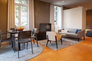 a living room with a couch and a table and chairs at Solar do Ribeiro in Funchal