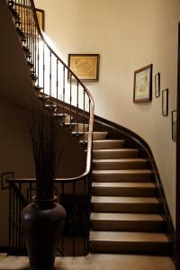 a spiral staircase with a vase in a room at Villa St Simon in Blaye