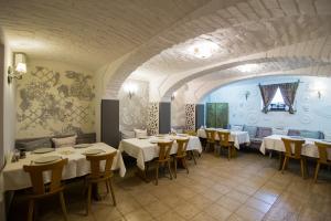 a restaurant with tables and chairs in a room at Vila Sibiu in Sibiu