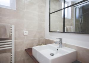 a bathroom with a white sink and a mirror at Maison d’hôtes Les Ajoncs in Sainte-Marie-de-Ré