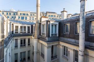 a group of buildings with smoke stacks at CMG Champs Elysées - Boetie 4DD in Paris