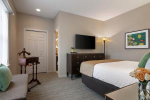 a hotel room with a bed and a television at The Glidden House in Cleveland