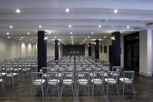 a large room with rows of chairs and a stage at Hotel Palacio de Mengibar in Mengibar