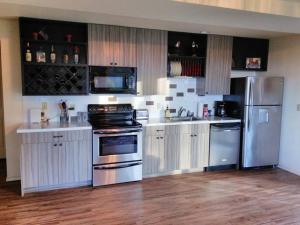 a kitchen with white cabinets and stainless steel appliances at Vancouver WA Beautiful Apartment in Woodland +9 photos