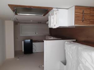 a room with a bed and a desk and cabinets at Dilmac Hotel in Gelibolu