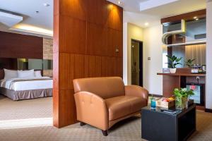 a hotel room with a chair and a bed at Da Vienna Boutique Hotel in Nagoya