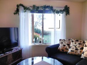 a living room with a couch and a window at Vancouver WA Beautiful Apartment in Woodland