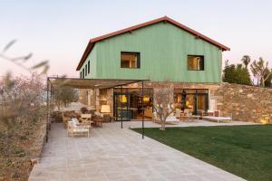 a house with a green roof and a patio at Quinta do Olival Loft Farmhouse in Douro Valley in Armamar