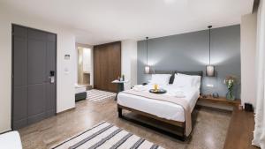 a bedroom with a large bed and a large window at Ciel Living Athens in Athens