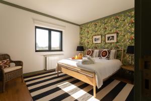 a bedroom with a large bed and a window at Quinta do Olival Loft Farmhouse in Douro Valley in Armamar +48 photos