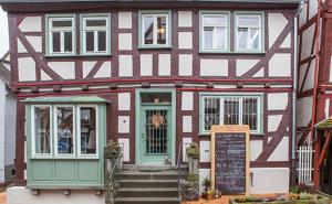 a red and white building with a sign in front of it at Träumerei in Laubach