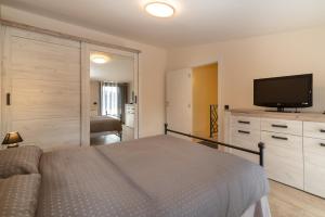 a bedroom with a bed and a flat screen tv at Central point Valjevo in Valjevo