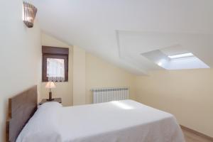 A bed or beds in a room at La Resplenda