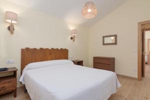 A bed or beds in a room at La Resplenda