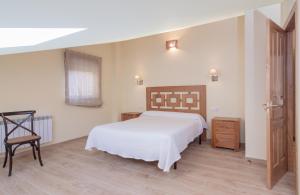 A bed or beds in a room at La Resplenda