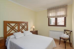 A bed or beds in a room at La Resplenda