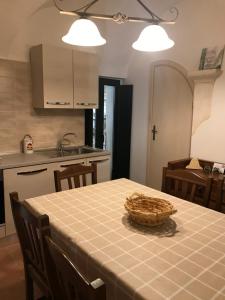 a kitchen with a table with a basket on it at Casa Cardi in Sperlonga
