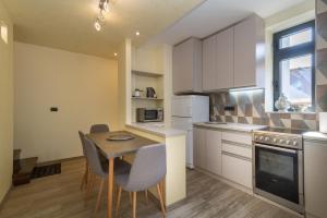 a kitchen with a table and chairs in a room at Central point Valjevo in Valjevo