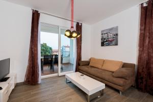 a living room with a couch and a table at Villa Anja 2nd floor in Peroj
