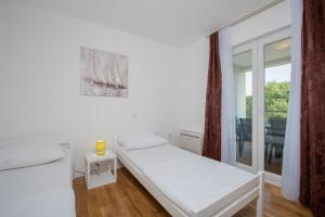 a white room with a bed and a balcony at Villa Anja 2nd floor in Peroj +77 photos