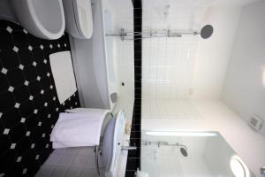 a bathroom with a shower and a sink and a tub at Hotel Ferton in Milan