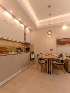 a kitchen and dining room with a table and chairs at Sofia Dream Apartment - Premium One Bedroom on Ekzarh Yosif in Sofia