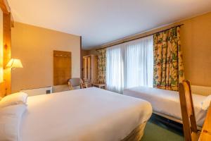 Postel nebo postele na pokoji v ubytování Sport Hotel