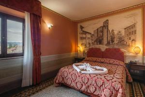 Postel nebo postele na pokoji v ubytování I Portici Hotel - Residenza D'Epoca