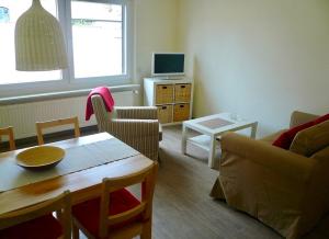 a living room with a table and a couch at Ferienwohnung Fam. Gansau - Insel Usedom in Zirchow