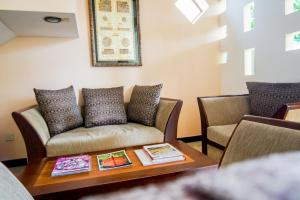 a living room with a couch and a table at Vivid Colombo in Colombo