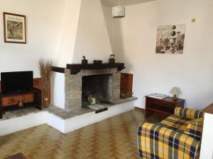 a living room with a fireplace and a couch at La Luna sul Tetto in Foligno