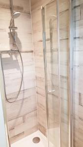 a shower with a glass door in a bathroom at Creaggan Ard Guest House in Kyle of Lochalsh