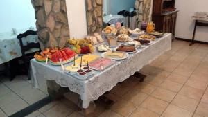 a table filled with different types of food on at Schulz Pousada in Joinville