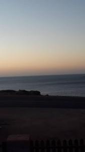 a view of the ocean from the beach at sunset at Seabreeze Accommodation in L&uuml;deritz