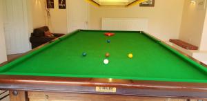 a pool table with three balls on top of it at Lower grange park in Chacombe
