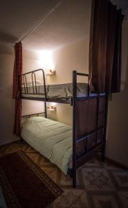 a bedroom with two bunk beds in a room at Mama Backpackers in Lima