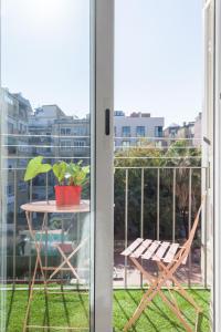 a table and a chair sitting on a balcony at Art House Fira Apartments in Barcelona
