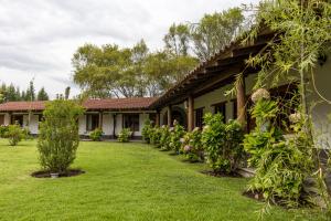 an exterior view of a house with a yard at Ensenada Hotel y Campo Asociado Casa Andina in Cajamarca