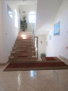 a staircase in a white room with a stair case at Art Depandansa in Zadar