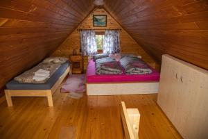 a bedroom with two beds in a log cabin at House Franja - Spa and relax in Kranjska Gora