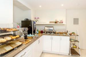 a kitchen with bread and other foods on a counter at Viewpoint Boutique Living in Xlendi
