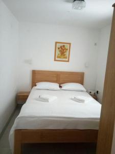 a bedroom with a large bed with two white pillows at Apartment NECA in Lovište